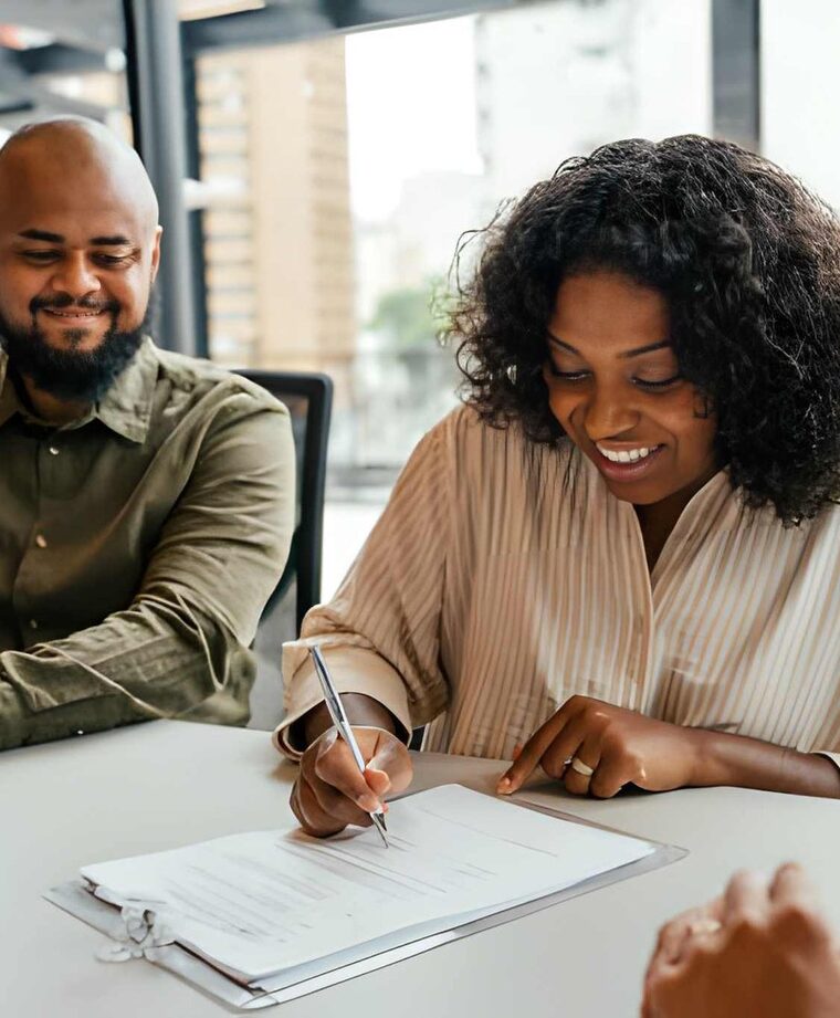 A client reviewing and signing a legal agreement during a consultation